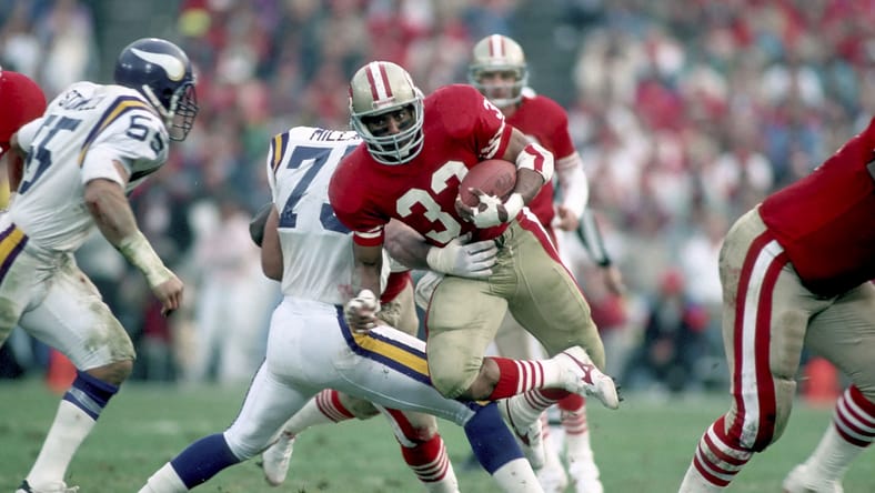 49ers running back Roger Craig runs the ball against the Vikings in a playoff game.