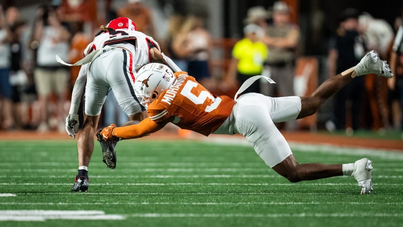 Malik Muhammad tackles Anthony Evans III during a Texas-Georgia game.