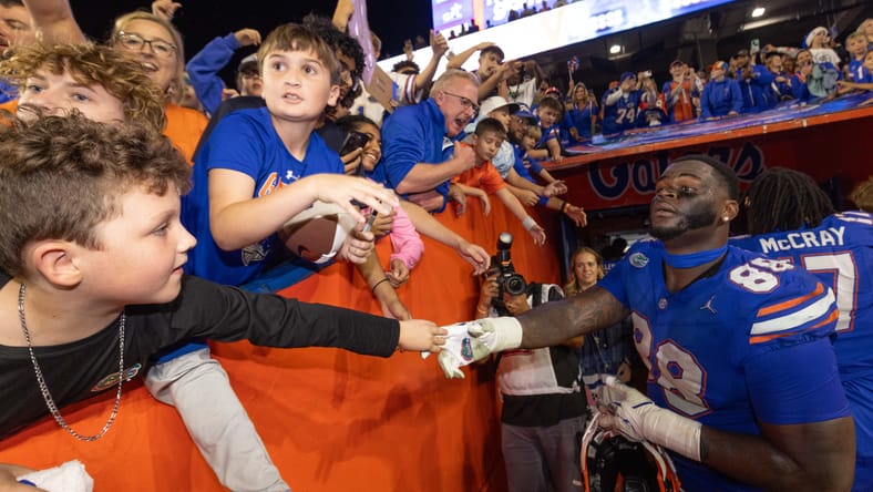 Caleb Banks shakes hands with fans after Florida victory.