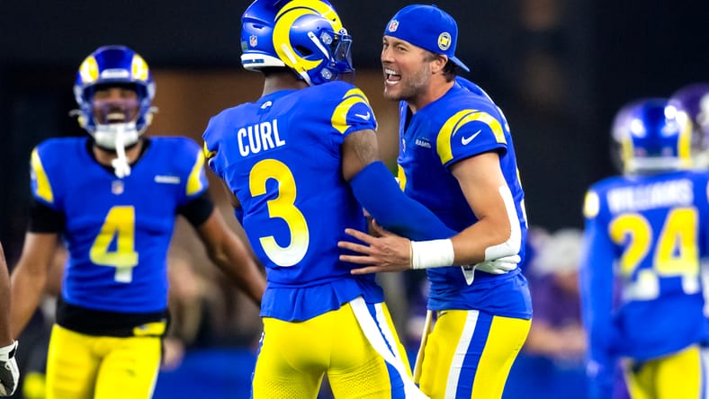 Matthew Stafford celebrates with Kamren Curl during a Rams playoff game.
