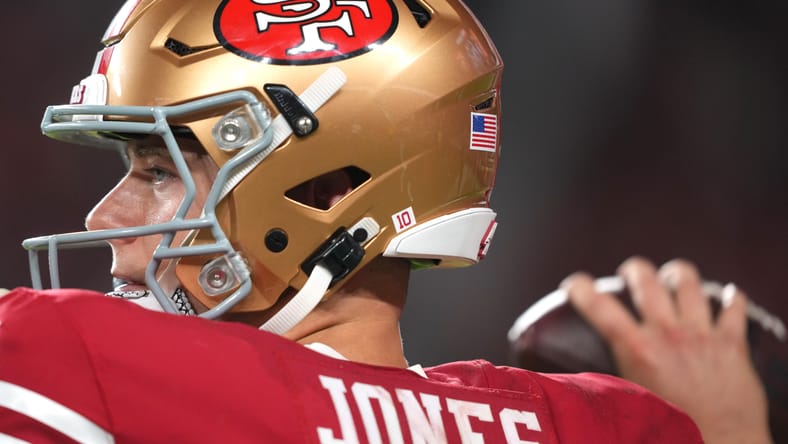 Mac Jones warming up on the sideline at Levi’s Stadium during a 49ers game. Minnesota Vikings Mac Jones trade.