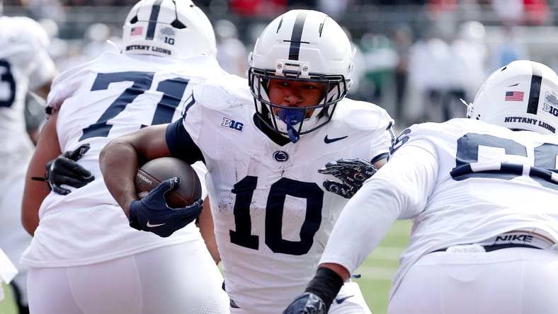 Nicholas Singleton runs for a touchdown during a Penn State game. Vikings interim GM headaches.