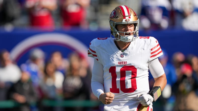 Mac Jones throwing during pregame warmups at MetLife Stadium before a 49ers game.