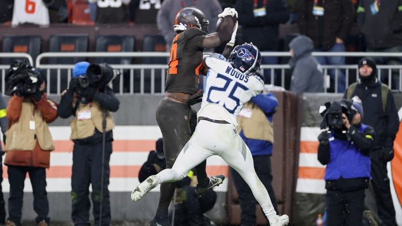 Harold Fannin Jr. catches a touchdown pass in front of Xavier Woods during a Browns-Titans game. Xavier Woods released.