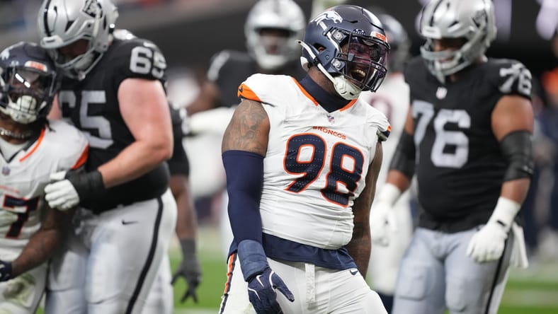 John Franklin-Myers celebrates after a sack against the Raiders