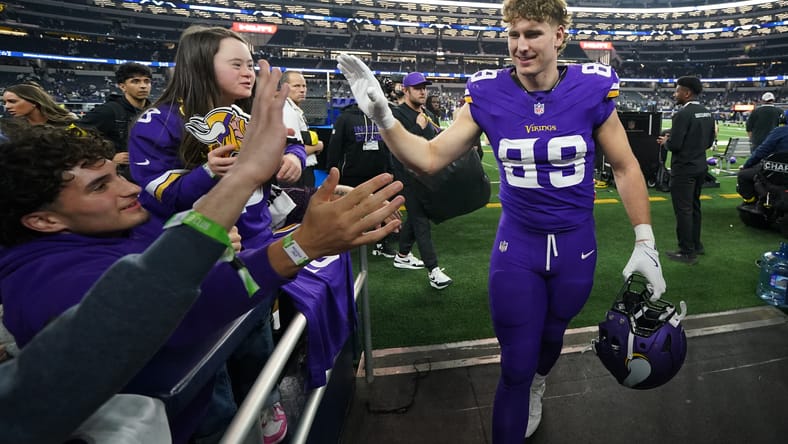Ben Sims celebrates with Vikings fans near the sideline after a road game. Vikings free agents 2026.