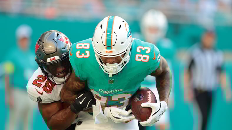 Darren Waller is tackled by Christian Izien during a Dolphins game at Hard Rock Stadium.