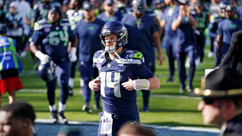 Sam Darnold warms up on the field before Super Bowl LX.