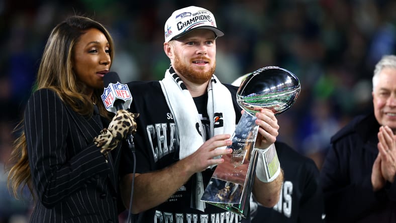 Sam Darnold holds the Vince Lombardi Trophy after the Super Bowl.