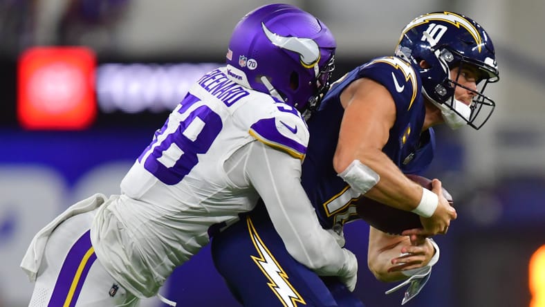 Jonathan Greenard pressures Justin Herbert during Vikings vs. Chargers game at SoFi Stadium.