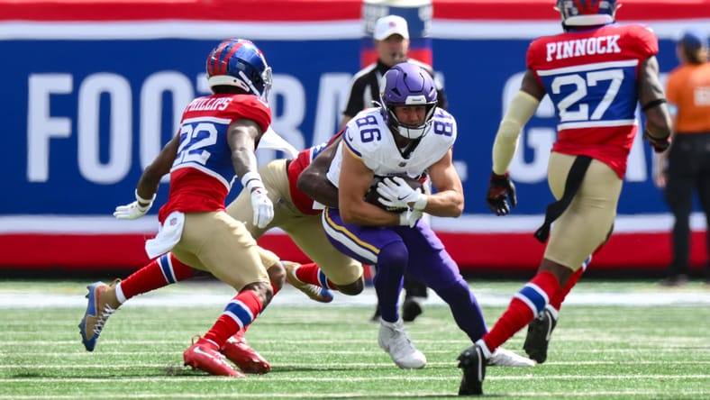 Johnny Mundt runs after a catch before being tackled by Bobby Okereke during a Vikings game against the New York Giants. Johnny Mundt Vikings
