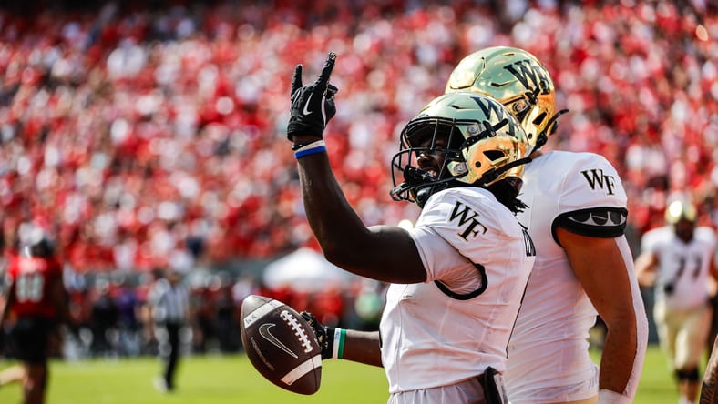 Demond Claiborne celebrates a touchdown for Wake Forest against NC State. Vikings rookie running back