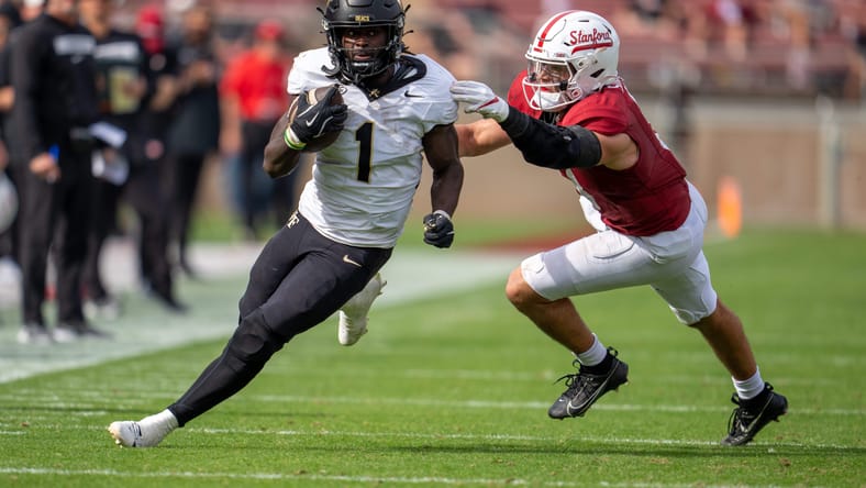 Demond Claiborne breaks a tackle against Stanford while gaining a first down. Vikings rookie running back