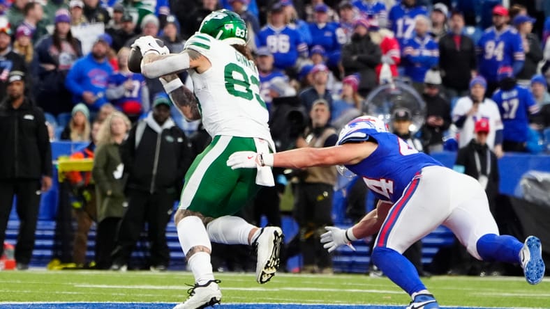 Tyler Conklin catches a pass for the Jets against the Bills at Highmark Stadium. Tyler Conklin Lions