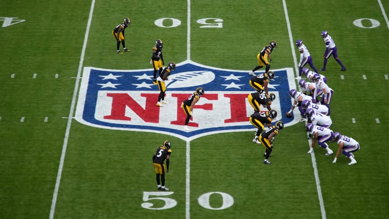 Carson Wentz taking a snap at midfield during a Vikings vs Steelers game in Dublin