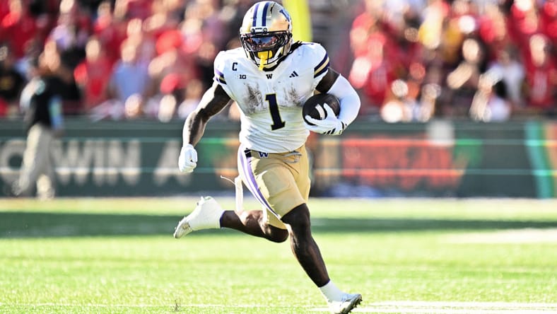 Jonah Coleman runs with the ball during a game against the Maryland Terrapins.