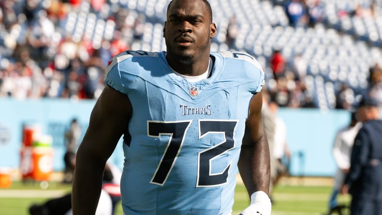 Olisaemeka Udoh walking off the field after a Titans game against the Patriots. Oli Udoh Cardinals.