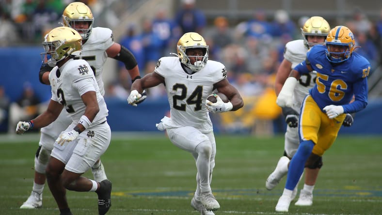Jadarian Price running through a hole against Pittsburgh defense during a Notre Dame game. Jadarian Price Vikings
