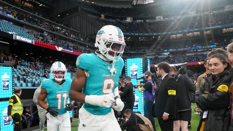 Dante Trader Jr. and Ifeatu Melifonwu run onto the field before a Dolphins game in Madrid. Vikings free agents