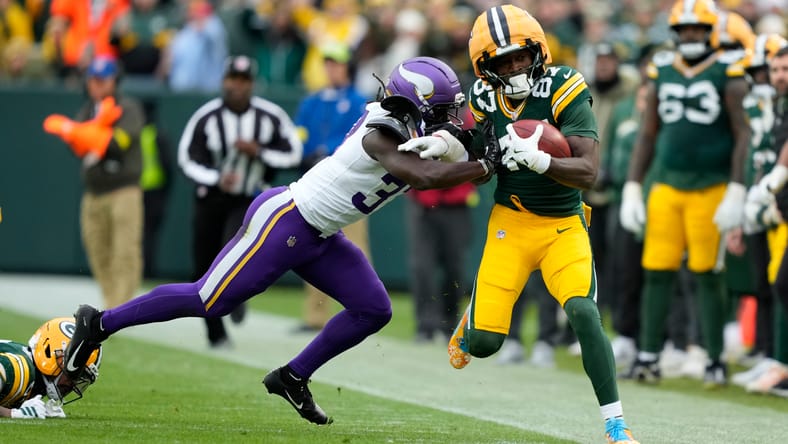 Vikings safety Tavierre Thomas pushes Packers receiver Romeo Doubs out of bounds during a game at Lambeau Field. Vikings Tavierre Thomas