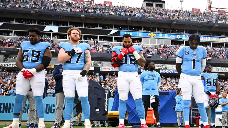 Titans players standing during national anthem before a game in Nashville. James Lynch Bears.
