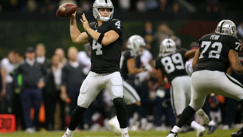 Derek Carr throwing a pass during a Raiders game against the Houston Texans at Estadio Azteca. Derek Carr Vikings.