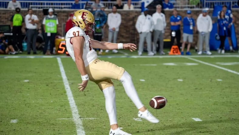 Matt Yurk punts the football during a game for Elon. Matt Yurk Vikings