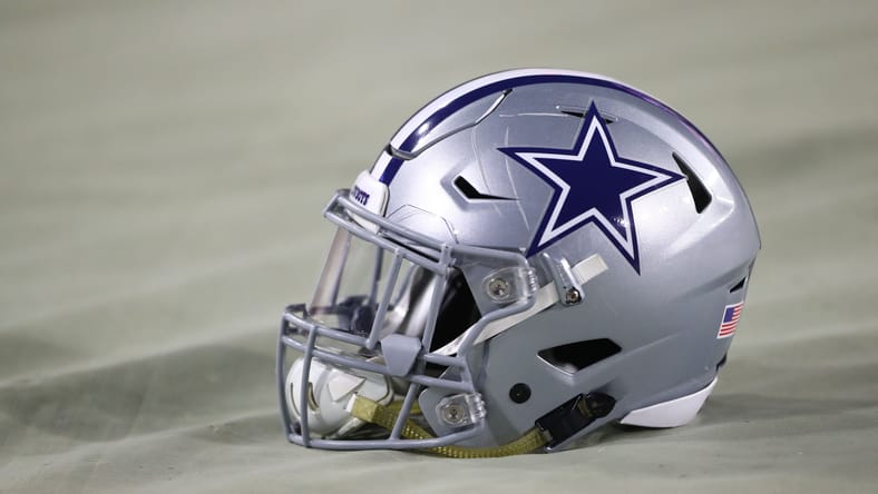 A Cowboys helmet on the field in 2017 before a game against the Cardinals