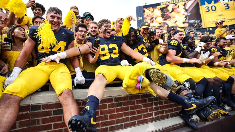 Max Bredeson celebrates with Michigan teammates after a win at Michigan Stadium.