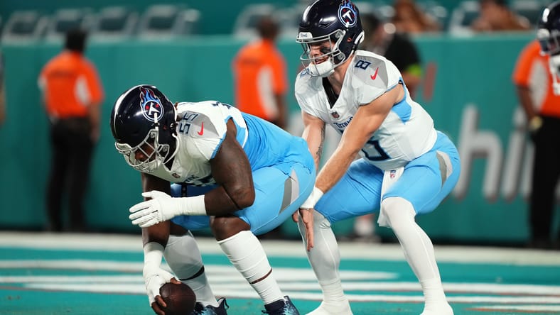 Aaron Brewer warms up with Will Levis before a Titans game. Vikings Aaron Brewer