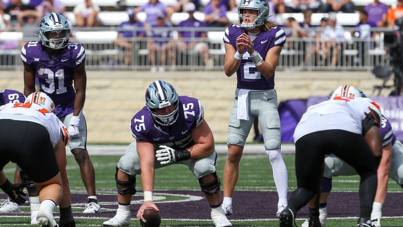 Avery Johnson lines up behind center before a snap against Oklahoma State. Vikings center draft