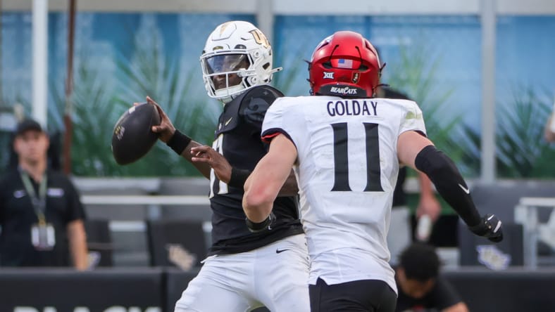 UCF quarterback Jacurri Brown prepares to pass while Cincinnati linebacker Jake Golday pressures him. Vikings Jake Golday.