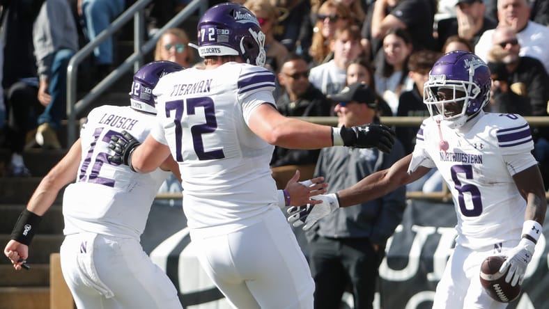 Caleb Tiernan celebrates a touchdown with teammates during a Northwestern game. Vikings rookies