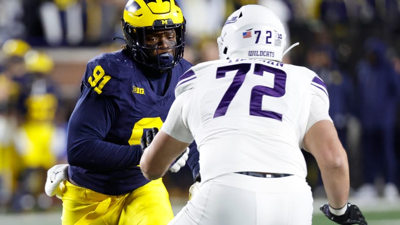 Caleb Tiernan blocks Cameron Brandt during a Northwestern vs Michigan game at Michigan Stadium. Caleb Tiernan Vikings