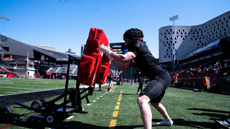 Jake Golday hitting a practice pad during Cincinnati Bearcats spring football practice. Vikings rookie to watch
