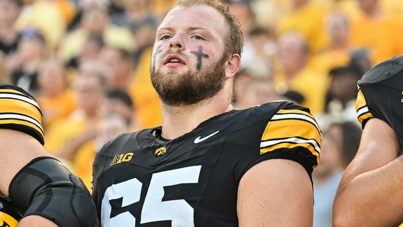 Logan Jones looks on during pregame warmups at Kinnick Stadium. Vikings center draft