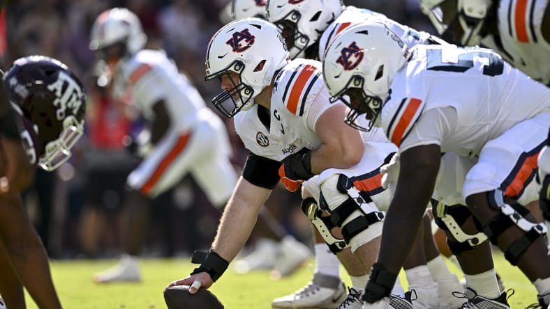 Connor Lew sets the ball on the line of scrimmage during a game between Auburn and Texas A&M. vikings draft needs 2026