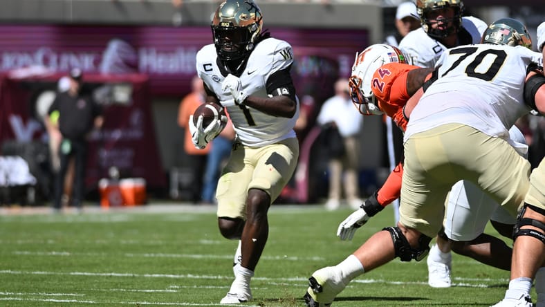Demond Claiborne runs the ball against Virginia Tech at Lane Stadium. Vikings draft