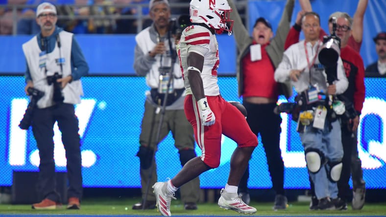 Emmett Johnson scores a touchdown during a game against UCLA at the Rose Bowl. Emmett Johnson
