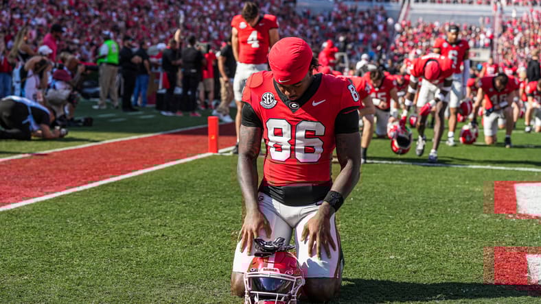 Dillon Bell standing on field before Georgia vs Charlotte game
