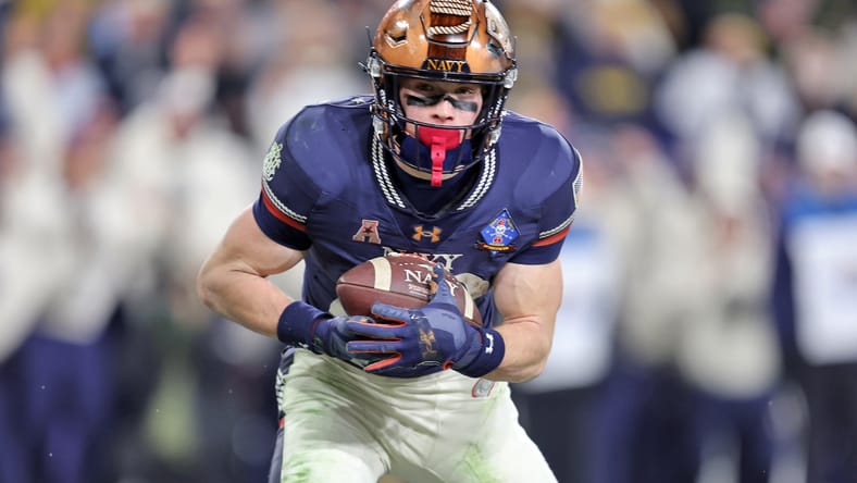 Eli Heidenreich catches a touchdown pass during the Army-Navy game. Vikings Saturday draft targets