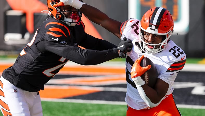 Geno Stone tackles Dylan Sampson during a game at Paycor Stadium. vikings rb trade targets