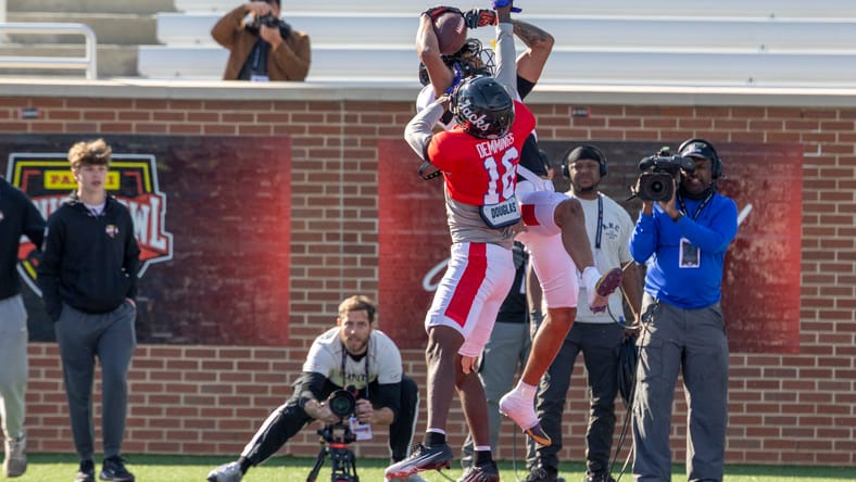 Reggie Virgil catching a pass over Charles Demmings during Senior Bowl practice.