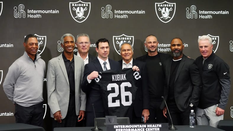 Klint Kubiak poses with Raiders legends and executives at his introductory press conference. Kirk Cousins Raiders
