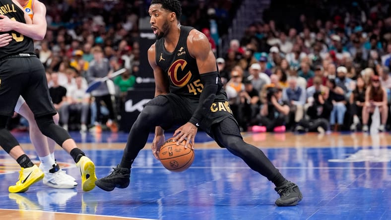 Donovan Mitchell dribbles the ball during a game against the Hornets at Spectrum Center. nba playoff predictions 2026