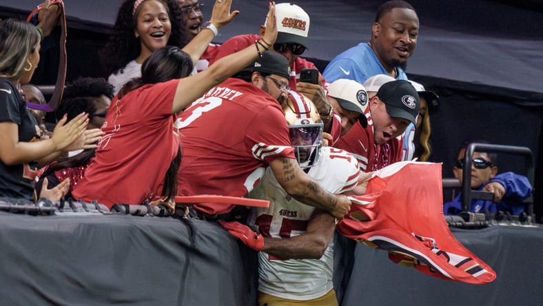 Jauan Jennings jumps into the crowd after a touchdown against the Saints at Caesars Superdome.