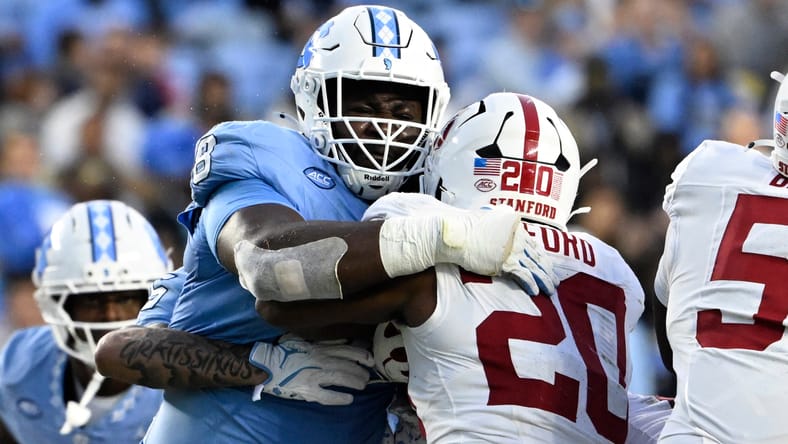 Smith Vilbert tackles Stanford running back Micah Ford during a game in Chapel Hill.