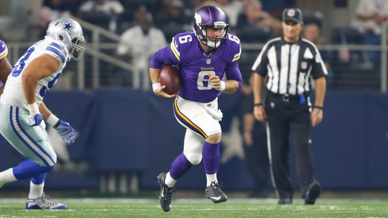 Taylor Heinicke runs with the football during a preseason game between the Vikings and Cowboys at AT&T Stadium.