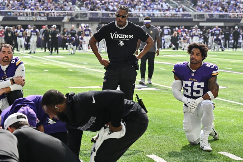 Justin Jefferson and Eric Wilson watch trainers tend to injured Rondale Moore during Vikings vs. Texans game.