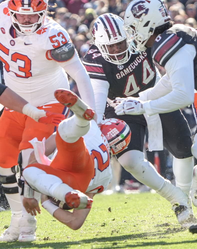 Clemson quarterback Cade Klubnik (2) is grabbed by thge facemask by South Carolina defensive lineman Monkell Goodwine (44)